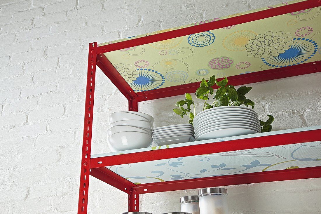 DIY kitchen shelves made from metal rails and wallpapered chipboard (detail)
