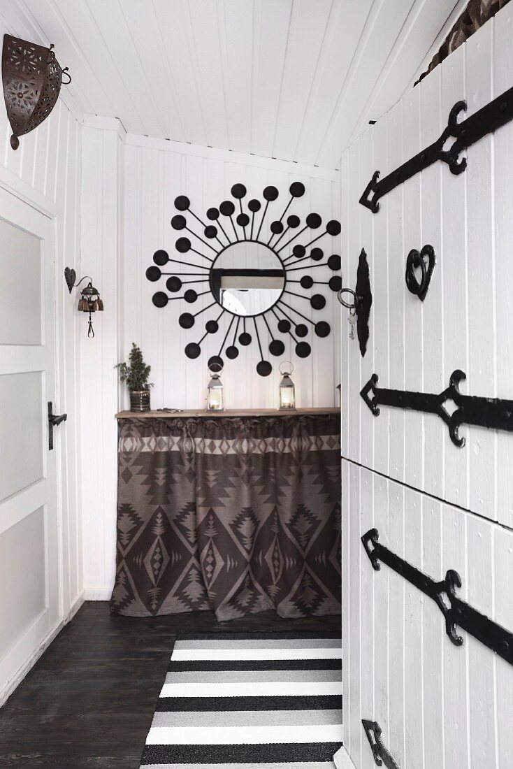 Ethnic-style entrance area with open white wooden door