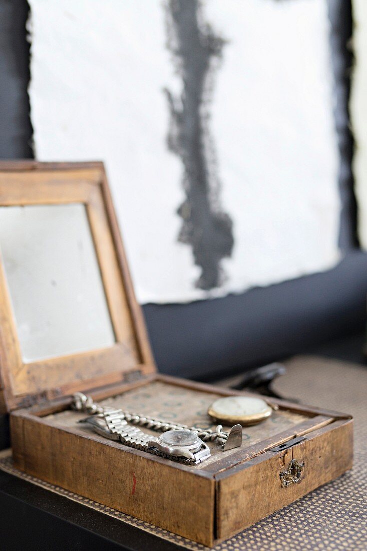 Offenes Vintage Holzkästchen mit Spiegel und ausgestellten Uhren