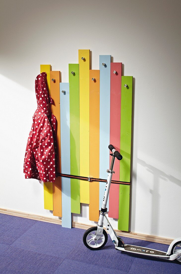 DIY children's coat rack made from wooden boards painted in bright colours