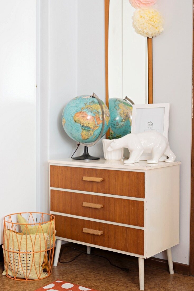 Globe and polar bear ornament on top of retro chest of drawers