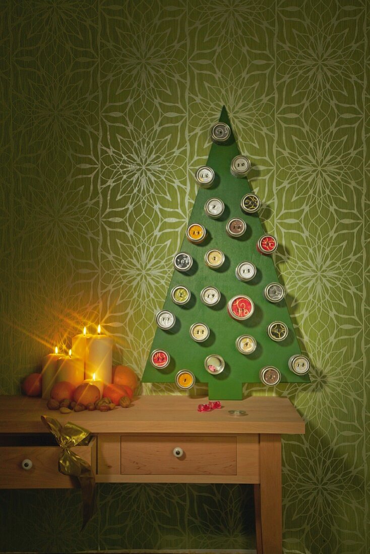 DIY-Adventskalender aus Metalldosen an stilisiertem Weihnachtsbaum