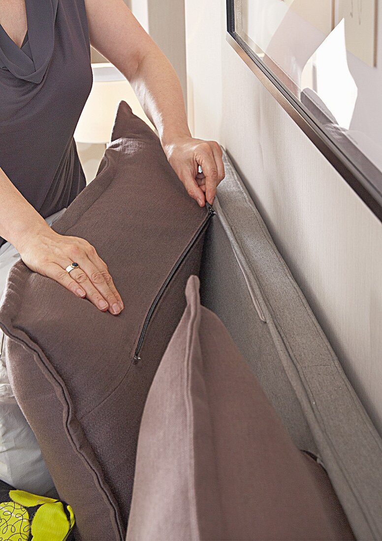 Back cushions attached to bed headboard with zips