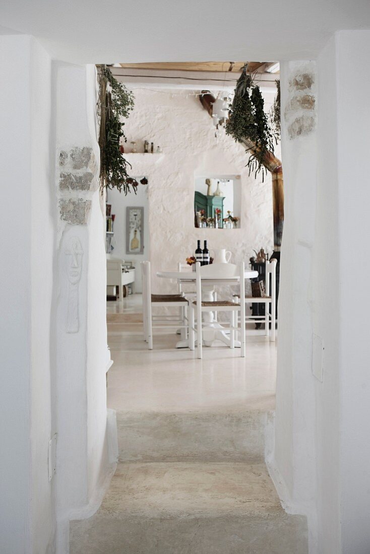 View into Mediterranean dining room with whitewashed walls
