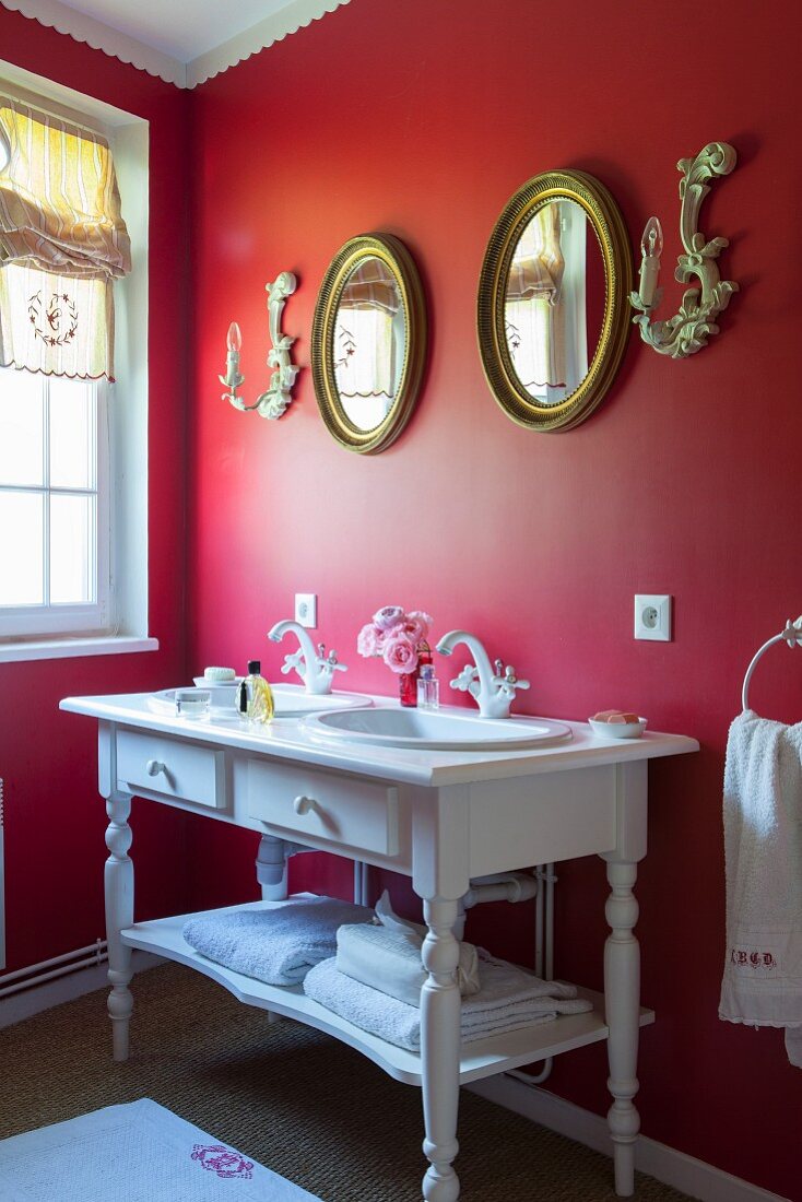 Vintage-style washstand against red wall