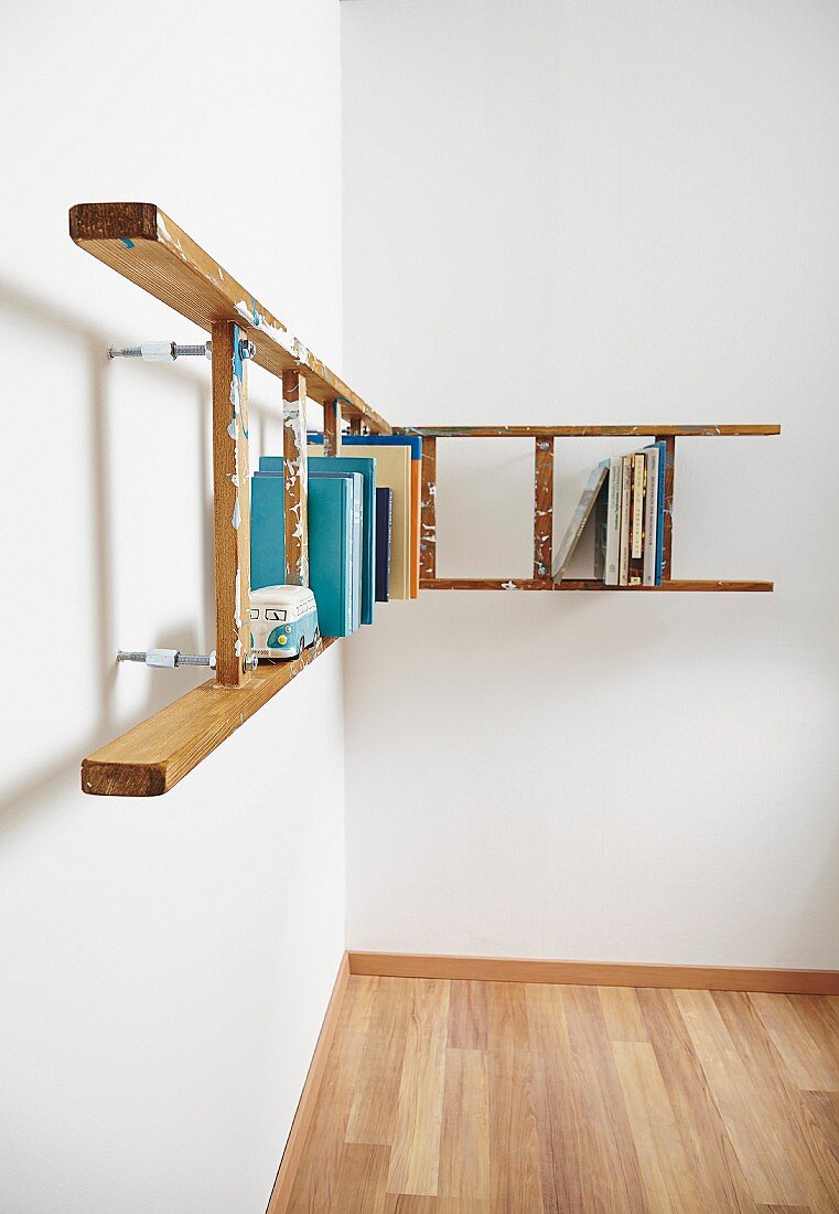 L-shaped bookshelf made from ladders running around corner