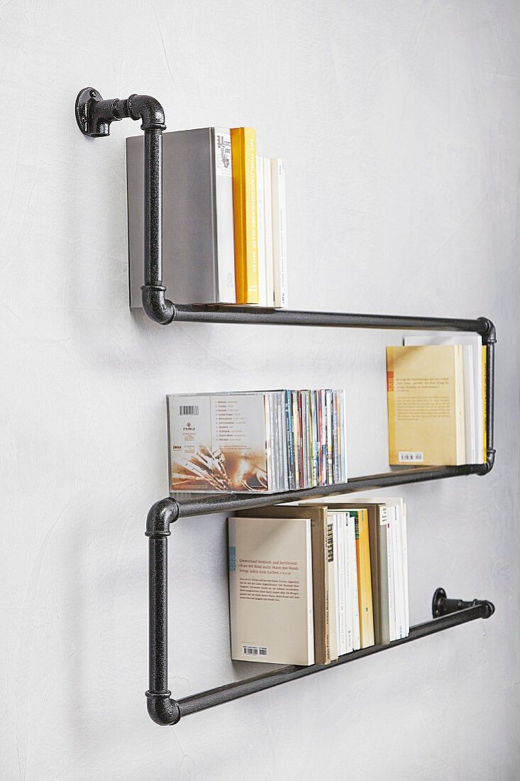 Wall-mounted shelves hand-made from metal pipes