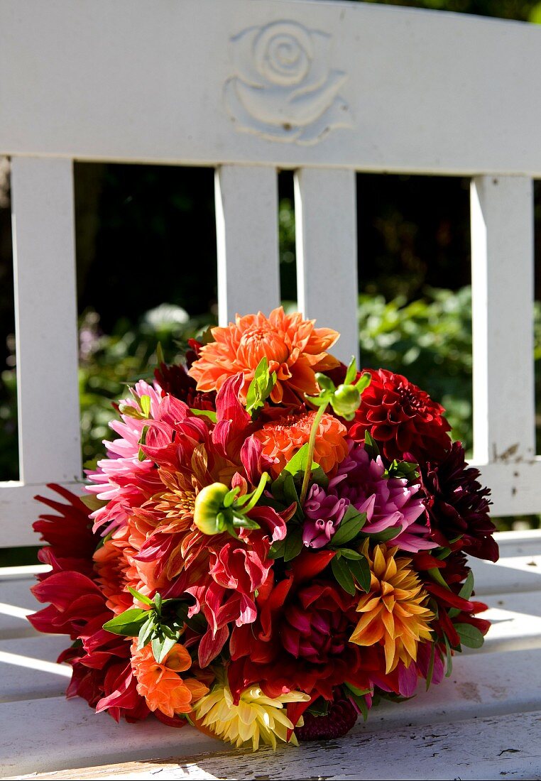Colourful bouquet of dahlias on bench