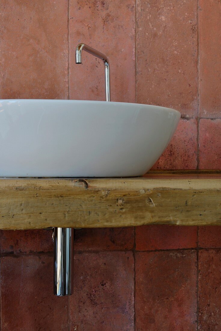 Modern countertop sink on rustic board