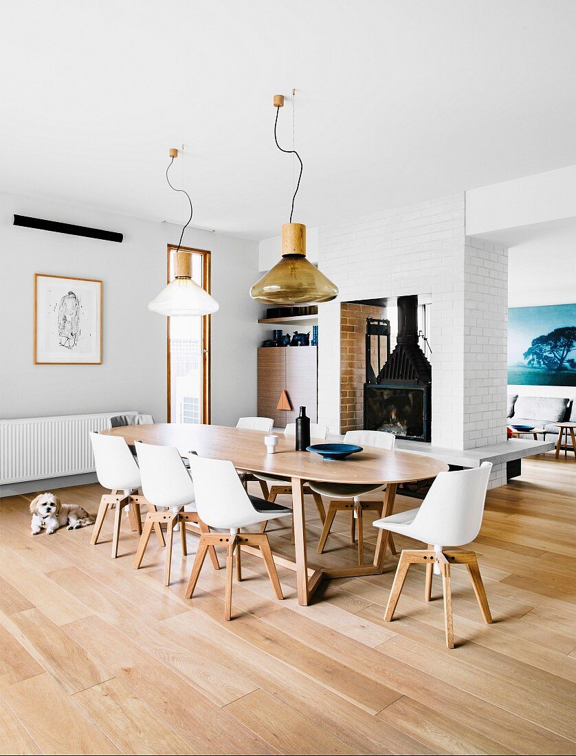 Large dining room with long table, designer chairs and XL pendant lights