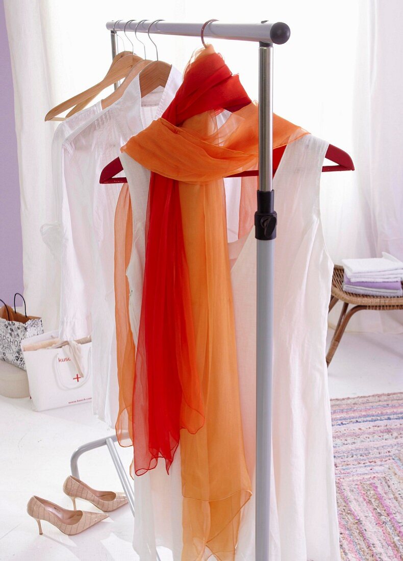 Dyed chiffon scarves draped over a hanger