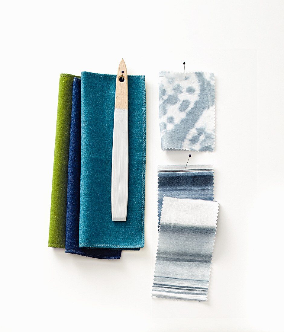 Pinned fabric and coloured swatches in blue tones