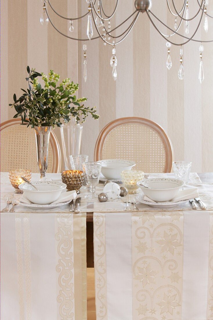 Table festively set with white runners and white crockery