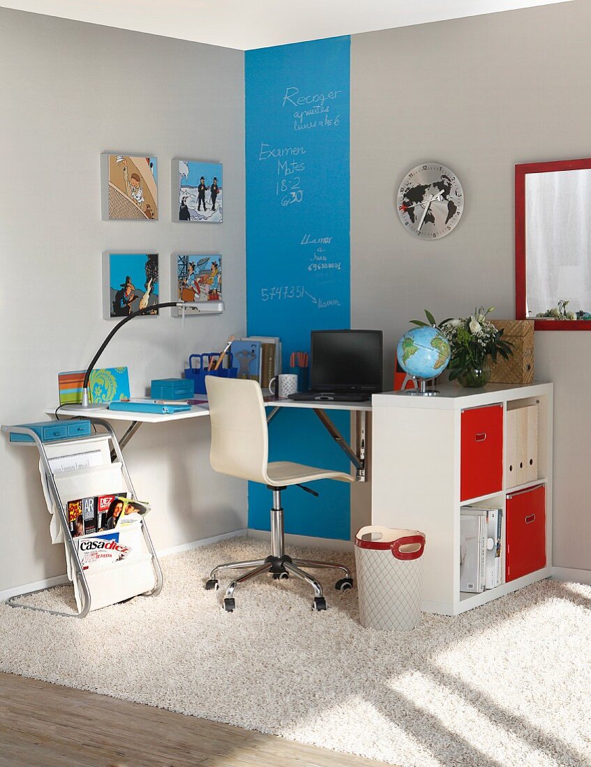 Work area with folding tables, shelves and blue chalkboard-paint stripe on wall