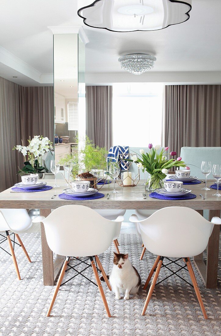 Spring dining table arrangement and plastic shell chairs in dining room