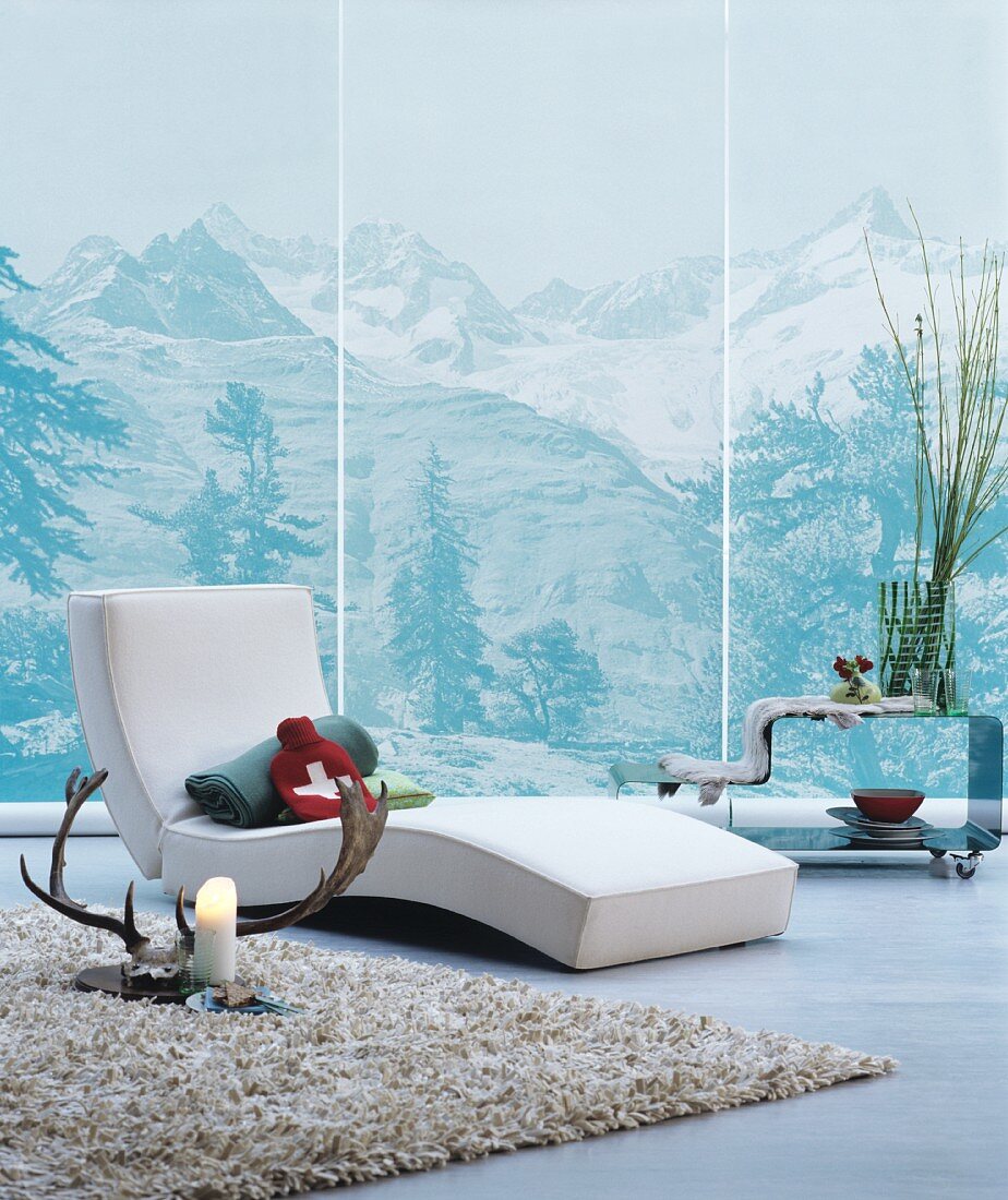 Modern lounger in front of wallpaper mural of mountains