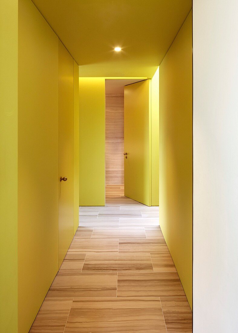 Yellow hallway with wood-effect tiled floor