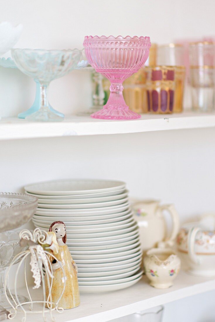 Crockery in white, shabby-chic, glass-fronted cabinet