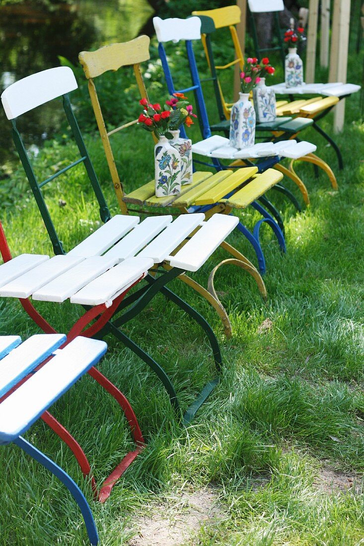 Einer Reihe von Vintage Gartenstühlen mit bunter Metallgestell