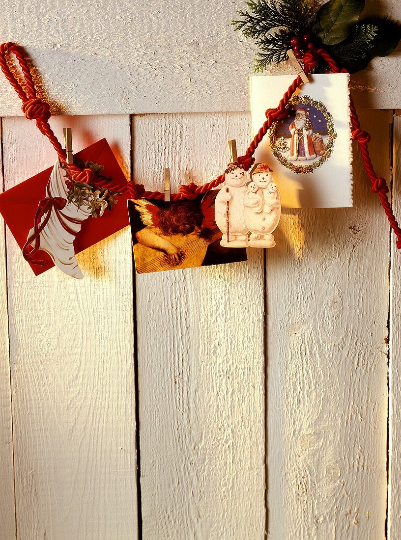 Christmas Cards Hanging From a Red Cord