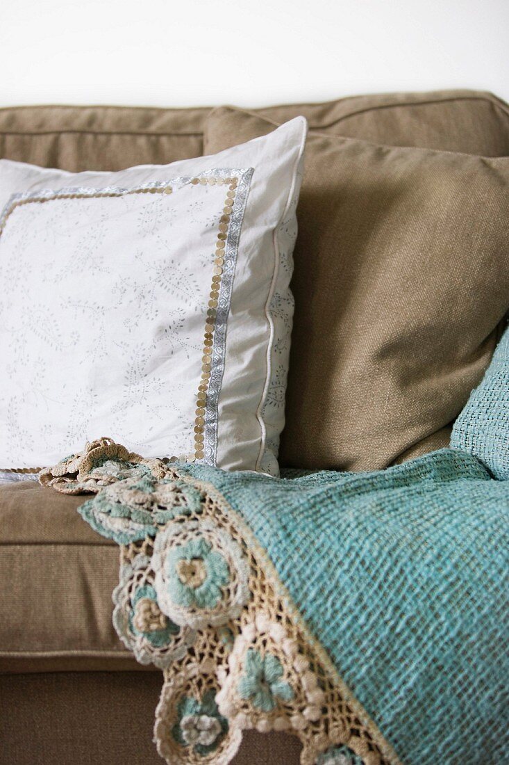 White cushion with trim on ecru sofa
