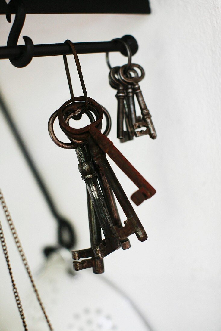 Bunches of vintage keys hanging from metal rod