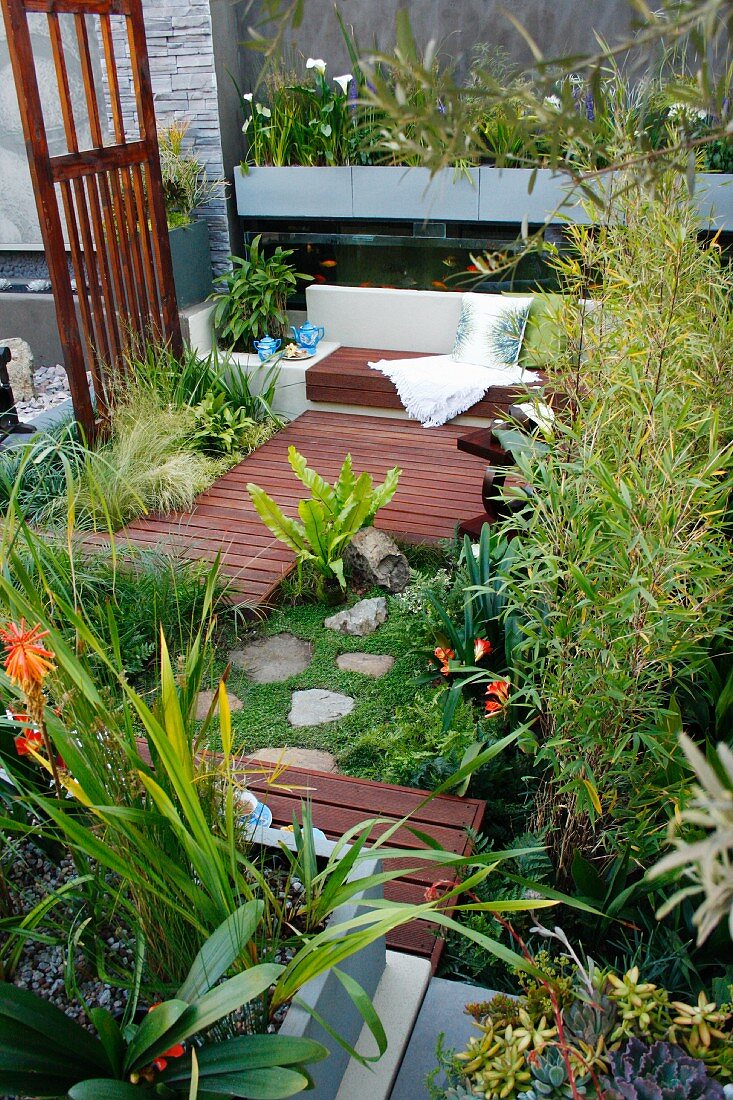 Planted courtyard with wooden deck and bench