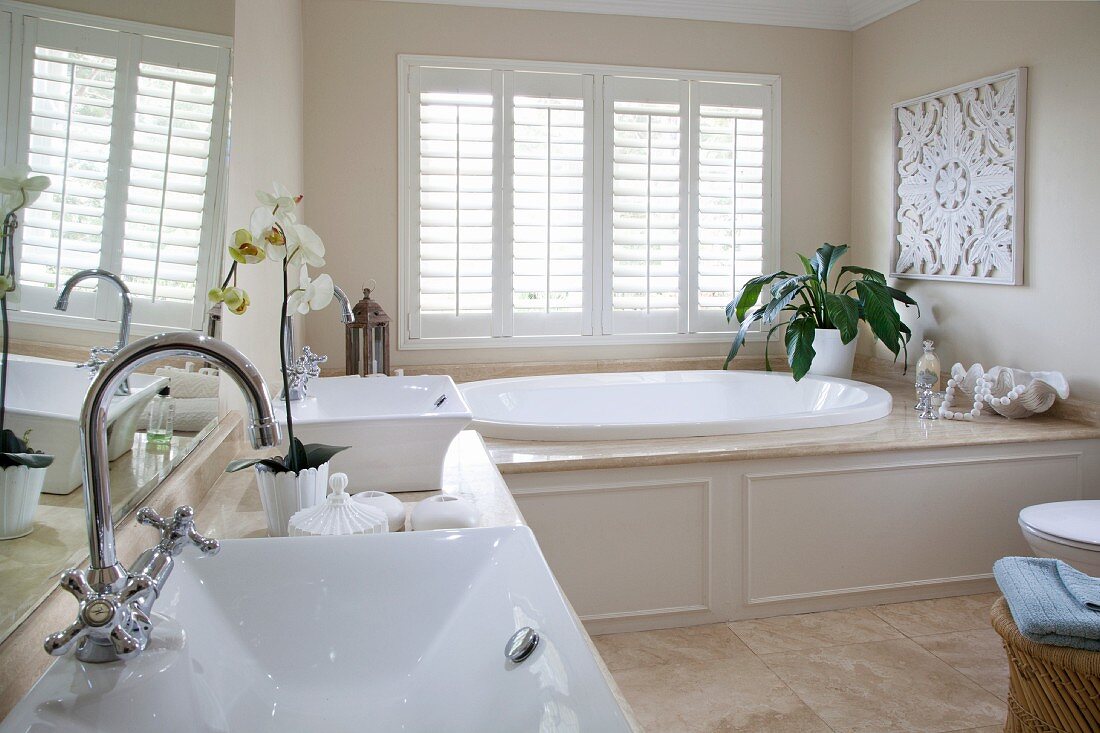 Elegant bathroom with twin washstand and large oval bathtub