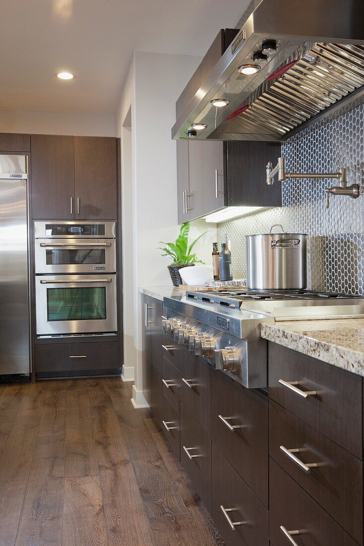 Kitchen with brown cabinets and vent hood; Irvine; California; USA