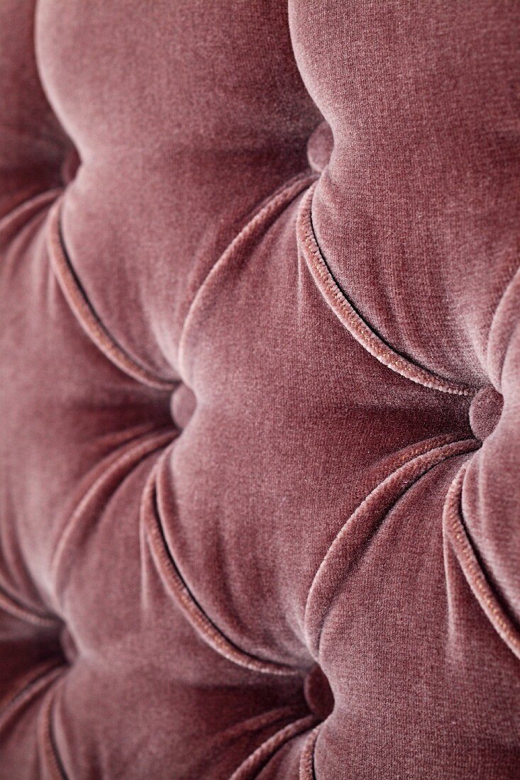 A brown velvet cover with upholstered buttons
