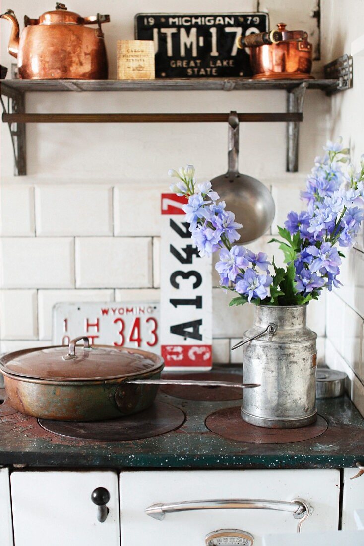 Nostalgischer Küchenherd mit Wandboard und Kupferkannen in schwedischer Vintageküche