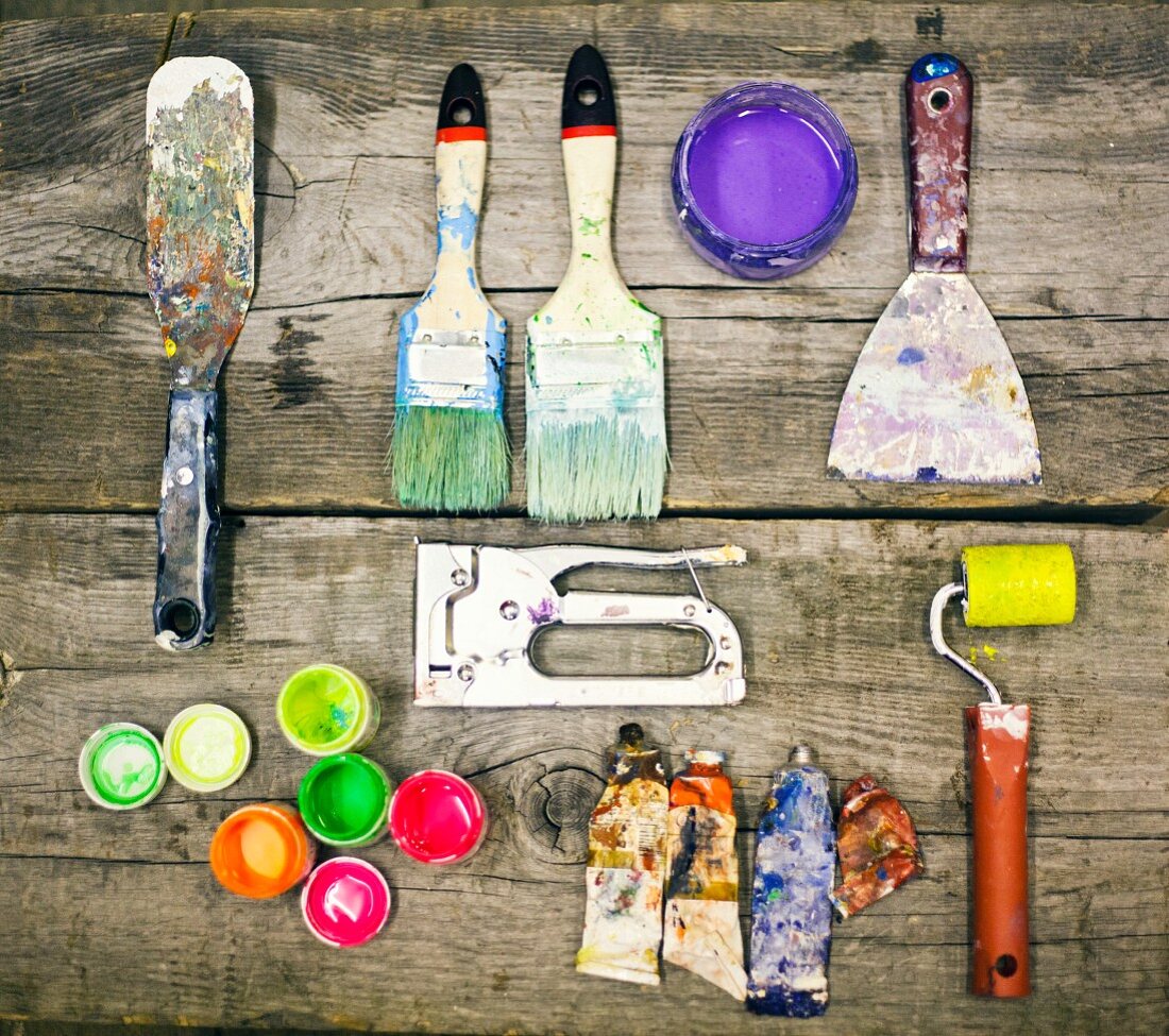 Painter's utensils on wooden table