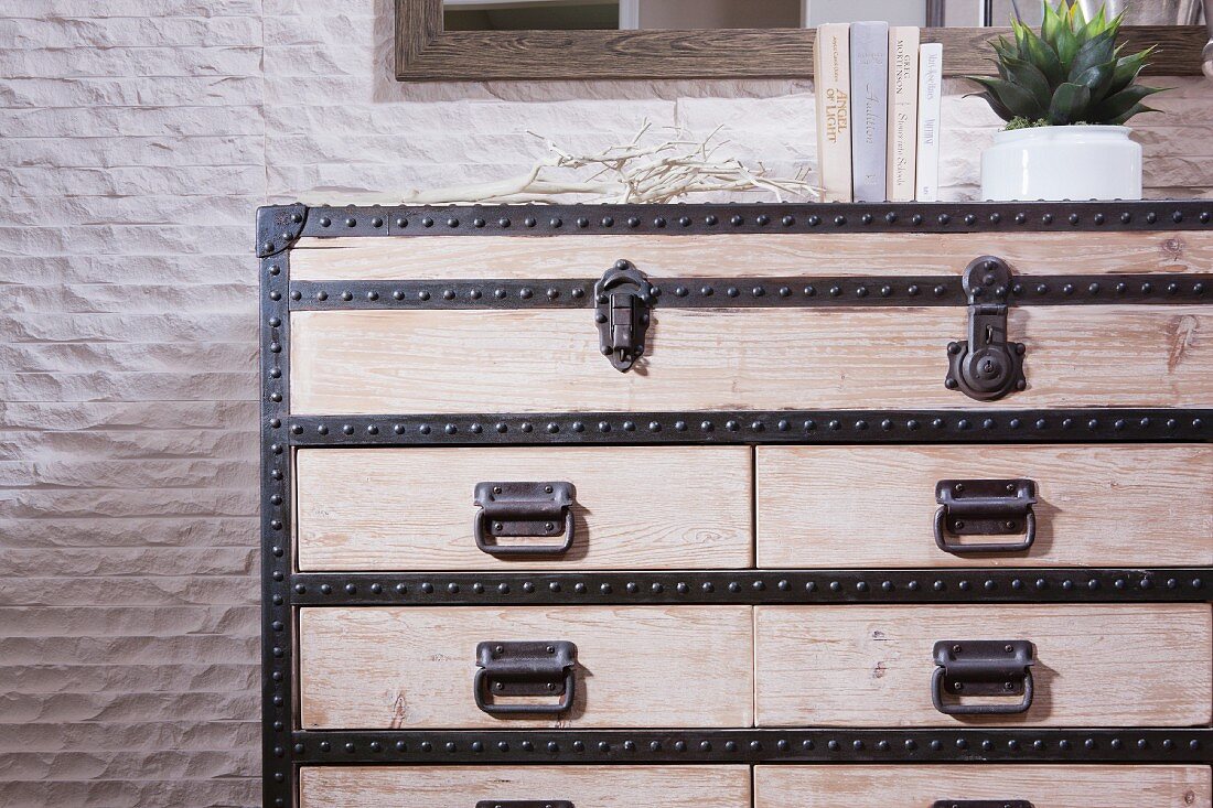 Wooden chest of drawers against wall