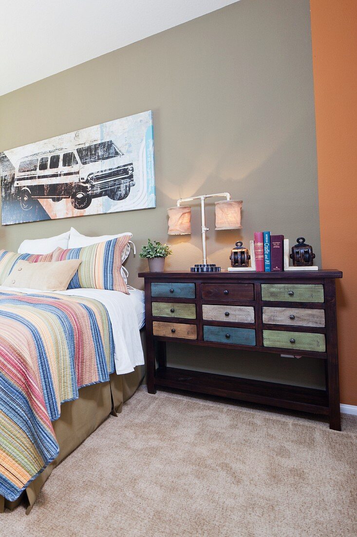 Chest of drawers by bed in bedroom