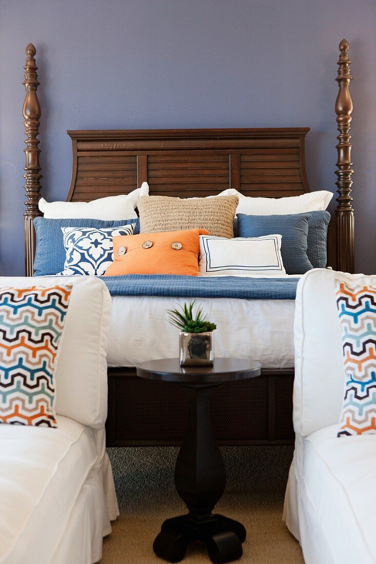 Cushions and pillows arranged on four poster bed; Valencia; California; USA