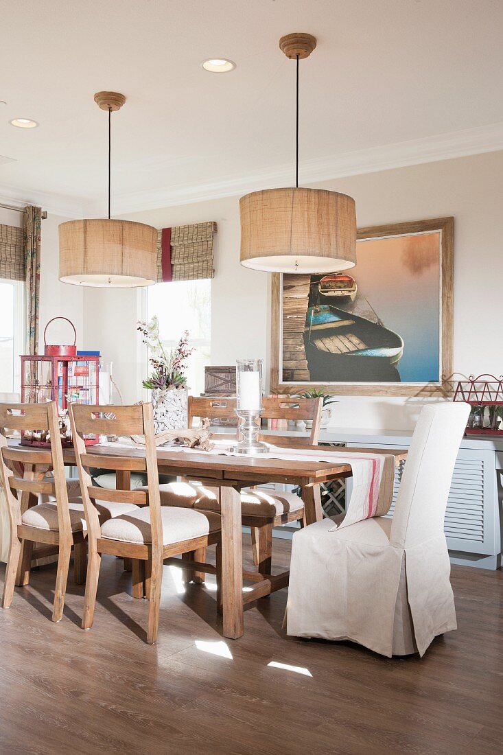 Chairs at dining table below pendant lamps