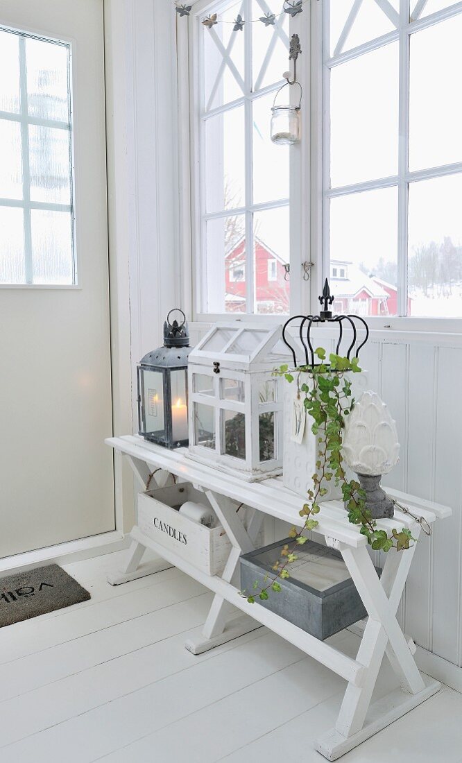 Shabby-chic arrangement in white foyer of Scandinavian wooden house