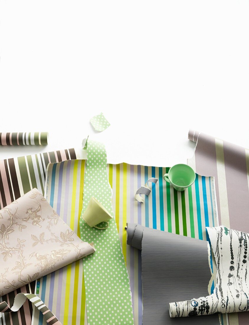 Rolls of wallpaper in different striped and floral patterns