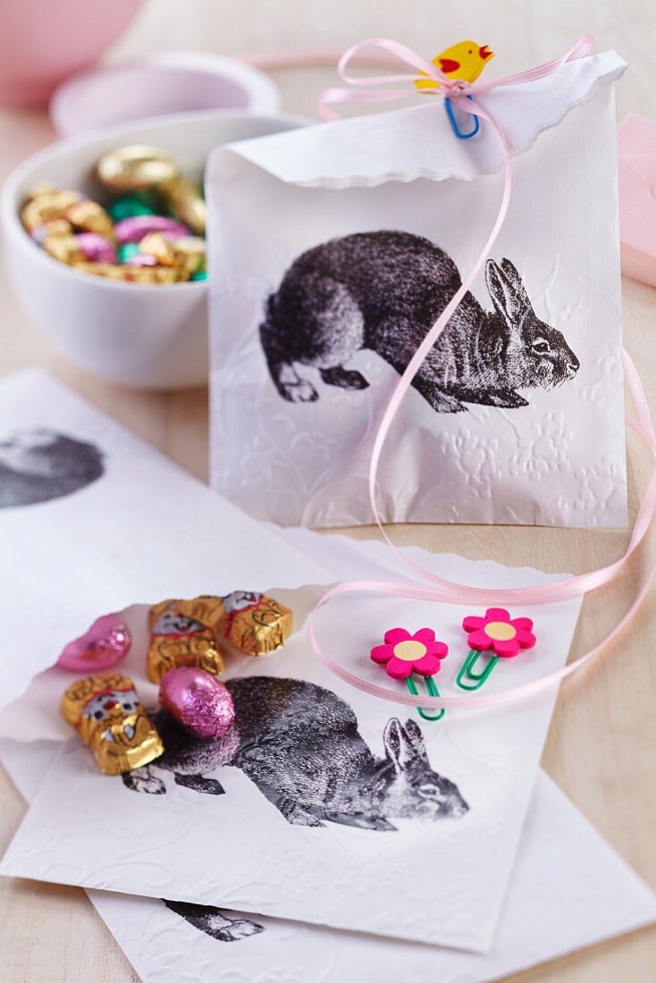 Bags for Easter treats decorated with rabbit motifs and held closed with decorative paper clips