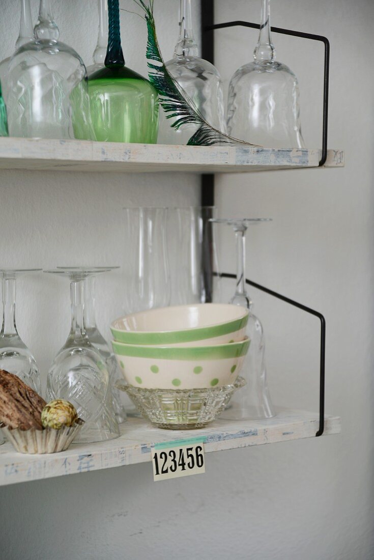 Glasses and bowls on 60s String shelving mounted on wall