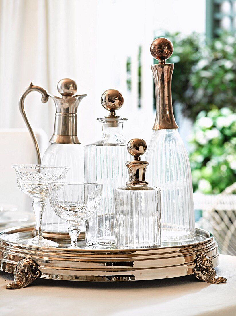 Elegant carafes and crystal glasses on silver tray