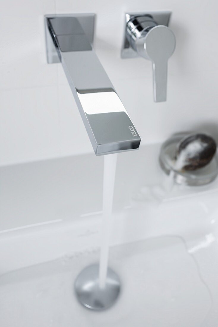 Water running from a square wall tap