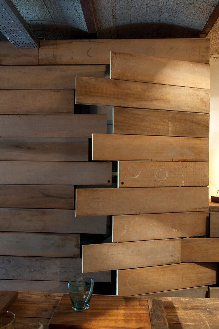 DIY cupboard door made from wooden planks in artistic interior