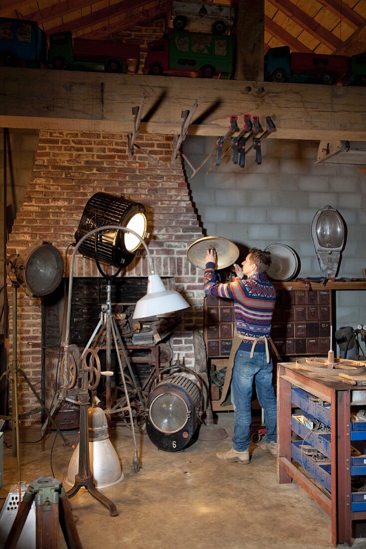 Vintage standard lamps and spotlights in rustic artist's studio
