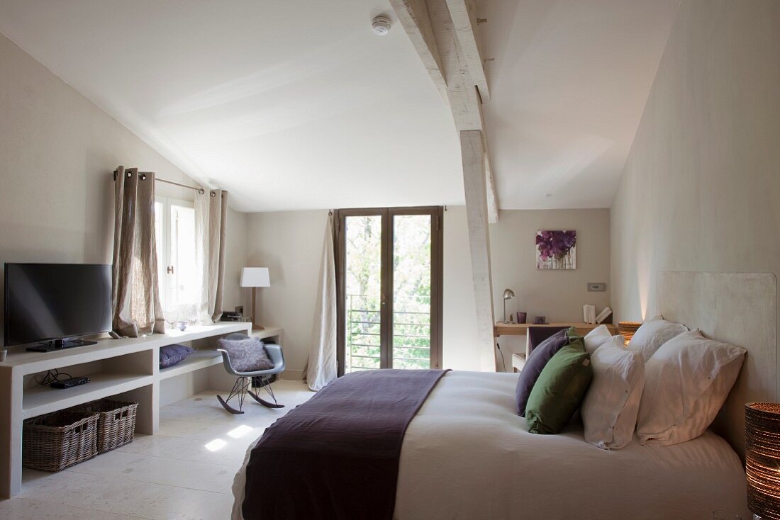 Subtle accents of colour in simple bedroom of Provençal guest house