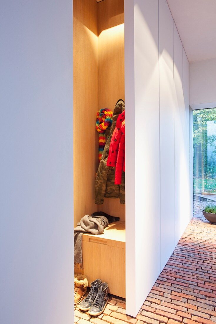 Brick-paved foyer with illuminated cloakroom niche