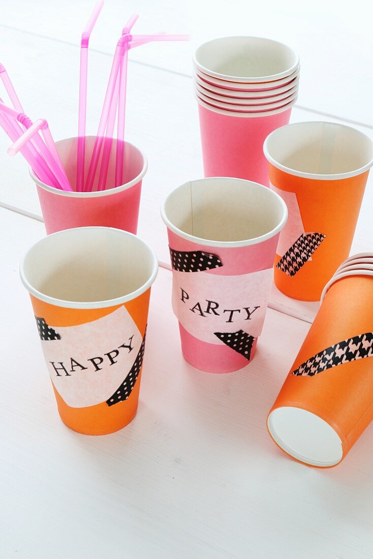 Paper cups decorated with washi tape and hand-stamped labels