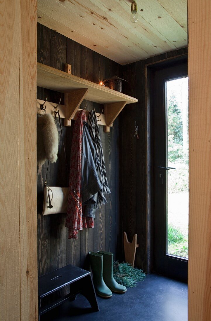 Open-plan cloakroom in wood-panelled foyer