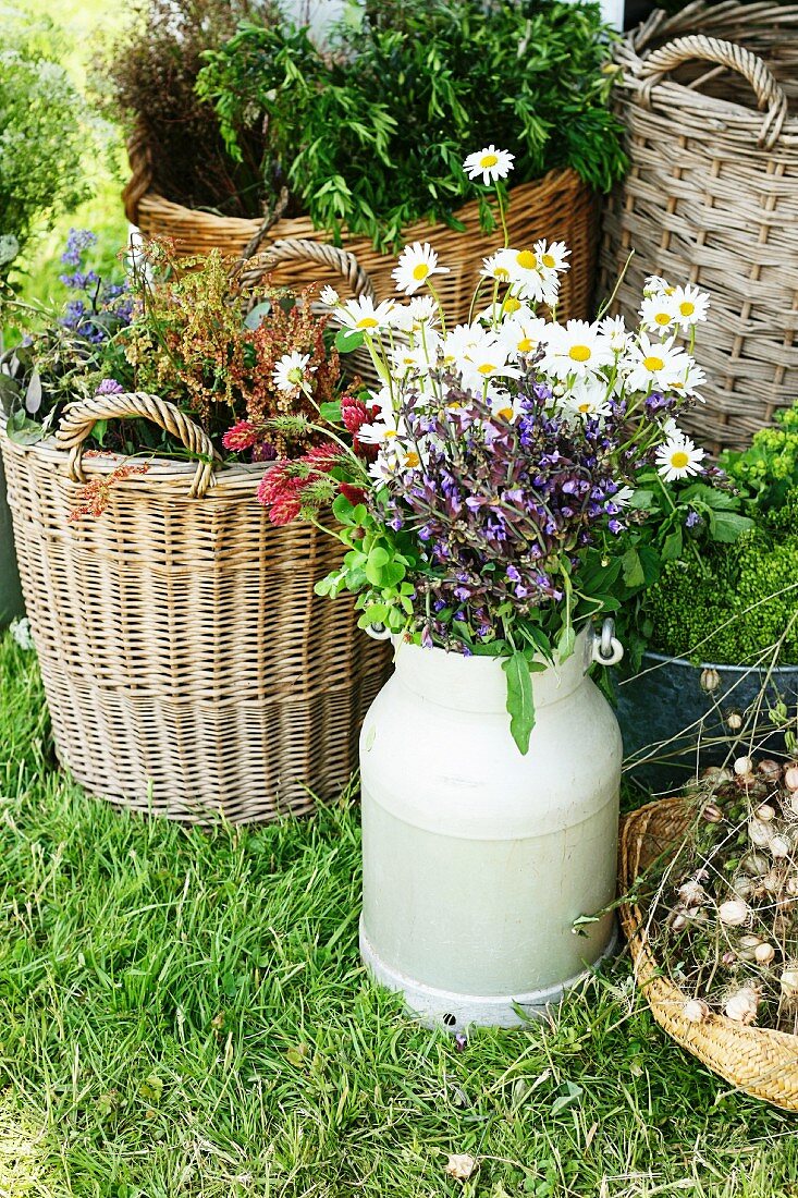 Plants in basket & bouquet in zinc milk churn