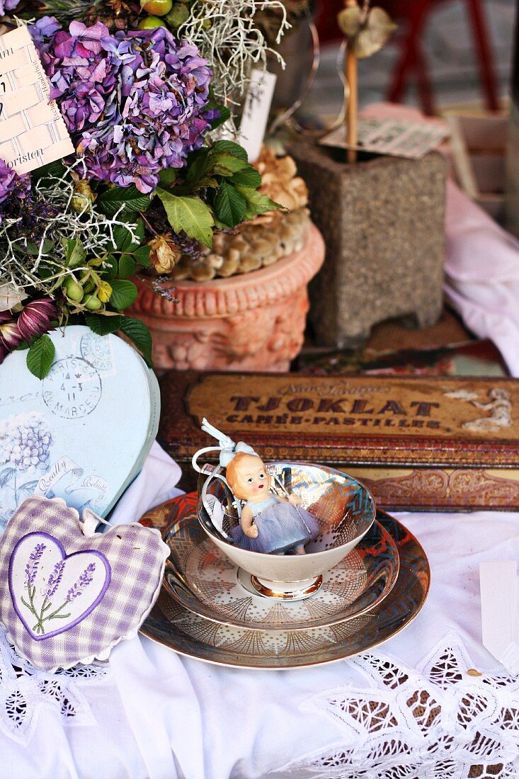 Vintage arrangement of antique teacup, hydrangea, lavender bags & boxes